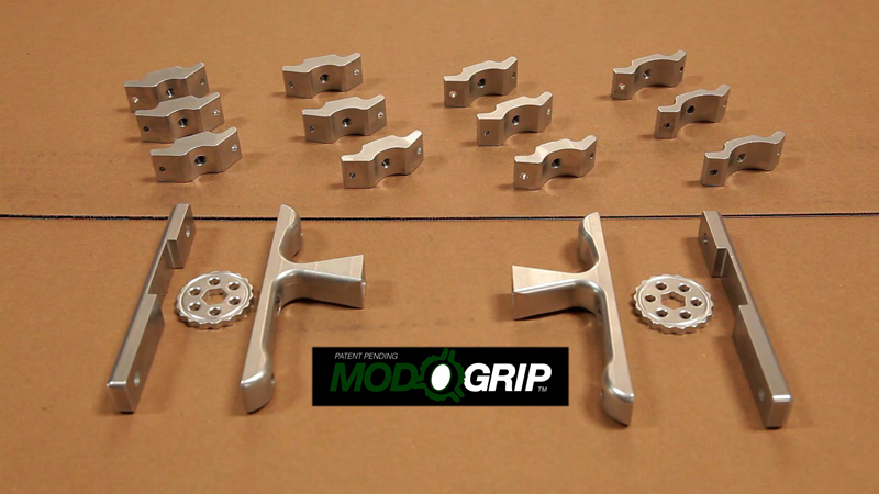 Silver metal parts, including clips and brackets, on a tan surface.