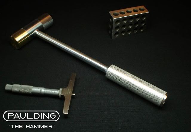 A small logo of The Hammer, a high-quality hammer for precision work.