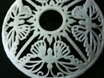 Intricate scrollwork designs on a circular object.