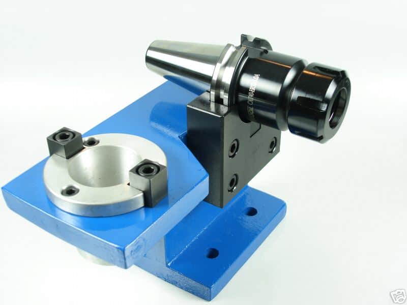 Blue vise with silver cylindrical component, black metal piece with holes, and silver circular base.
