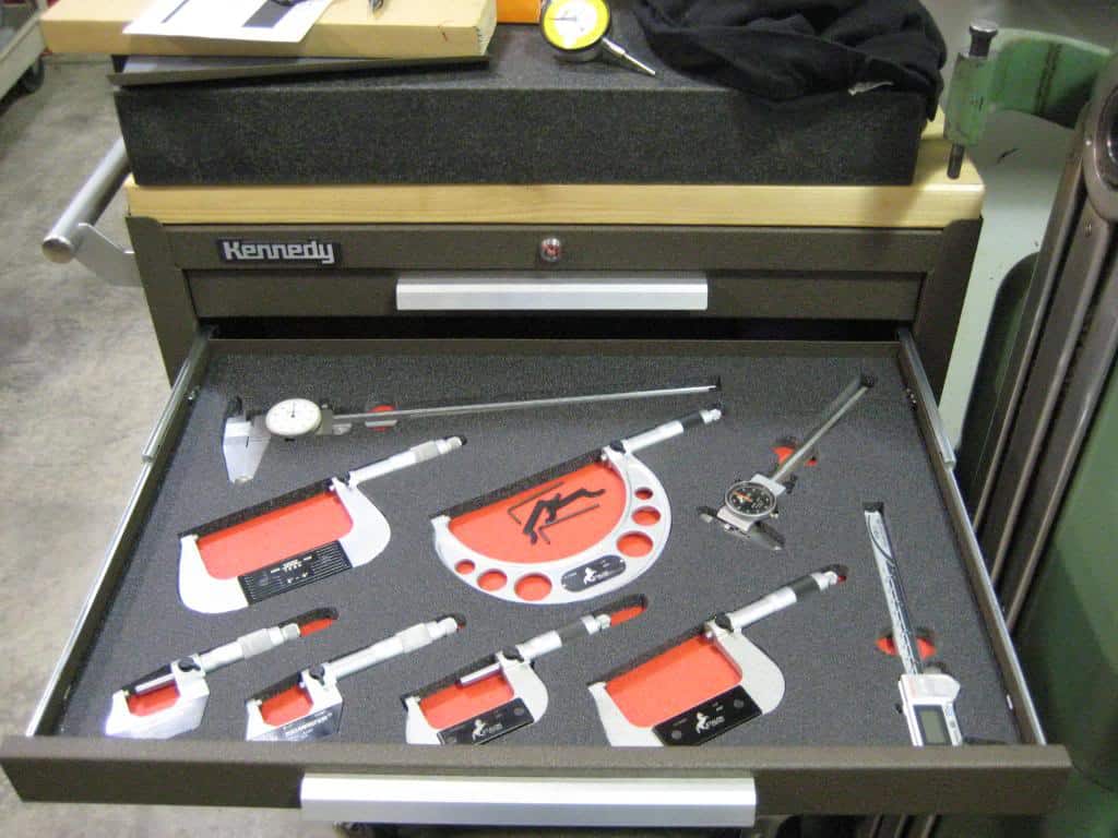 Micrometers and precision measurement tools in a neat drawer arrangement.