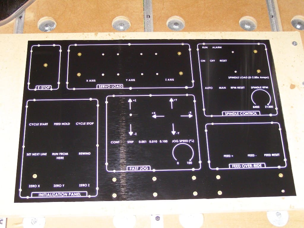 Control panel with E-STOP, servo load, spindle control and other machinery operating components.