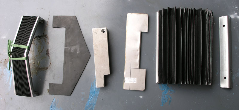 Metal components with ribbed surfaces on a gray background.