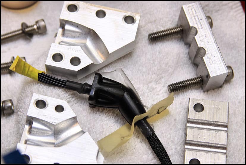 Metal parts, screws, and hardware components on a white surface.