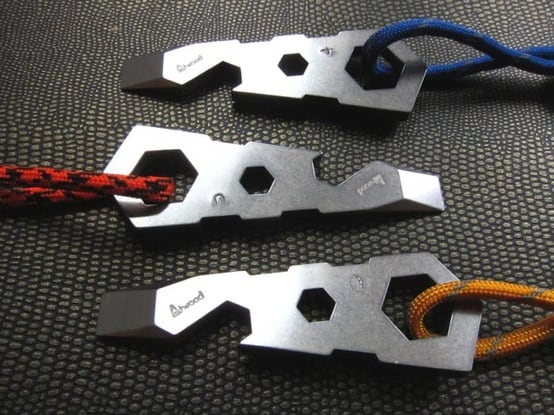 Two Atwood cord tighteners on a black textured surface.