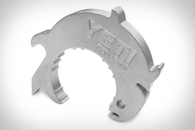 Metal tool with engraved "YETI" and tarpon fish design.