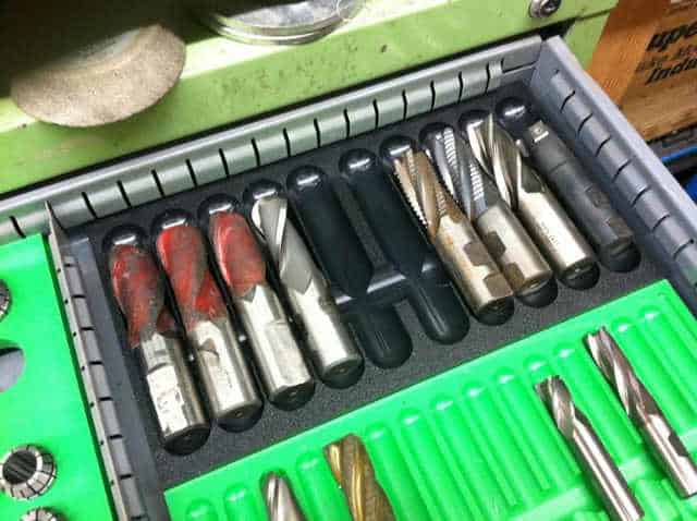 Metalworking tools in a toolbox drawer, organized by category.