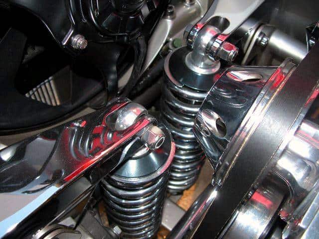 Motorcycle suspension system with chrome-plated coil spring.