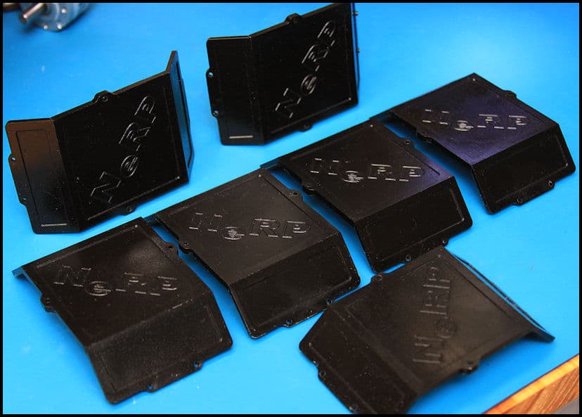 Black plastic ISRE parts on blue background.