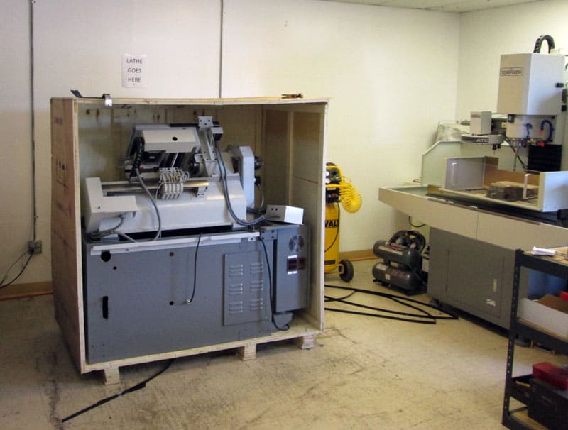 CNC lathe in a well-lit industrial setting.