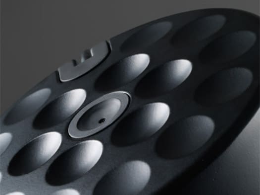 Black metal sphere with circular dimples in a symmetrical arrangement.