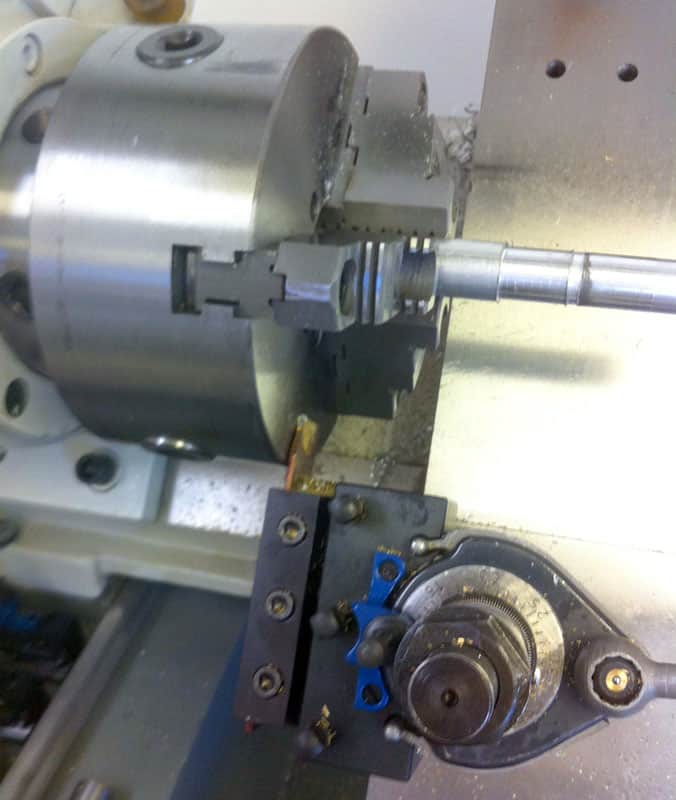 Squaring Parting Tool in use on a lathe or turning machine.