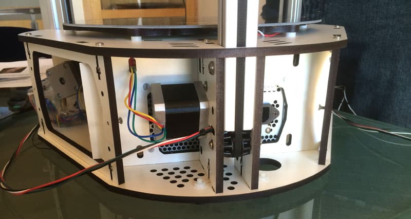 A complex metalworking machine with attached wires and components.