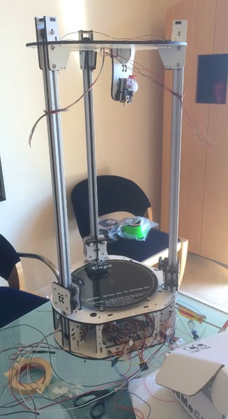 A 3D printer assembled with mechanical rails, showcasing its components.