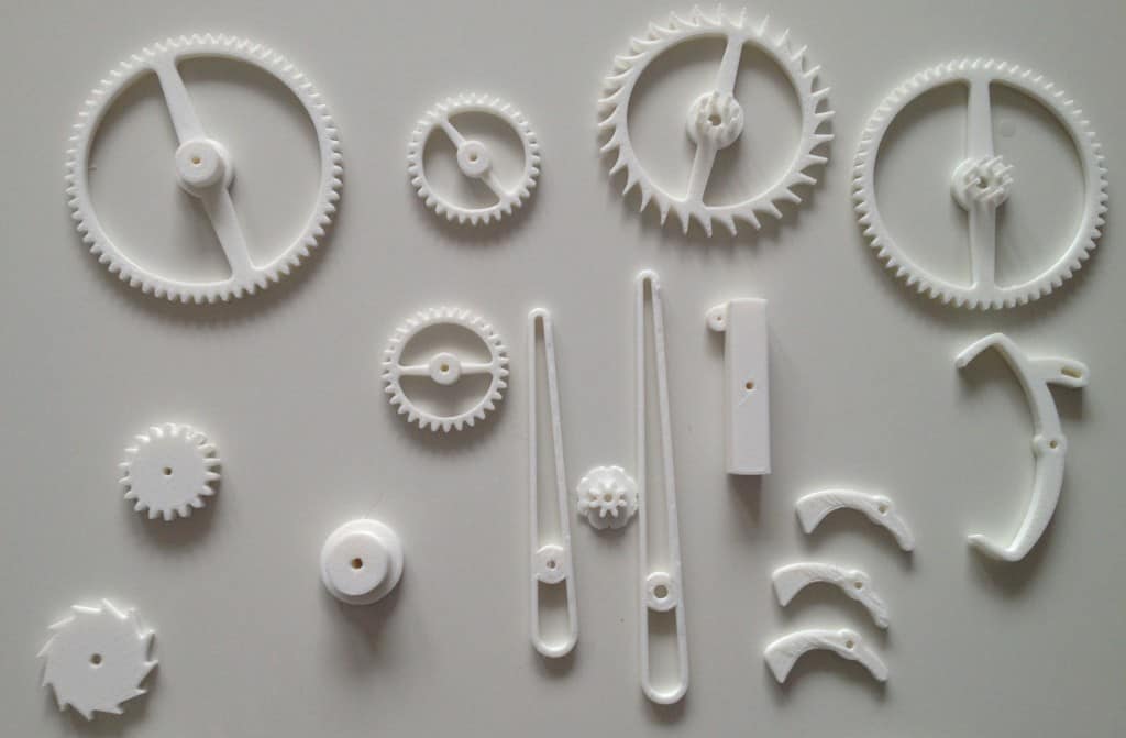 White plastic parts, gears, pins, and components.