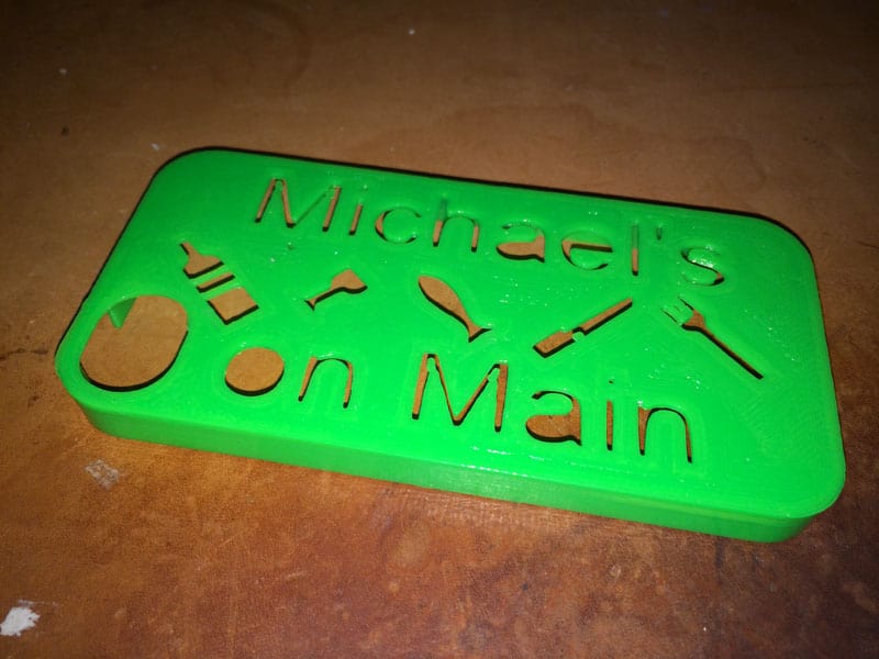 Green sign with rounded corners, featuring Michael's on Main text.