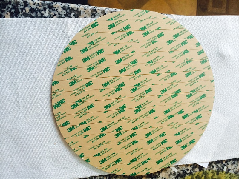 Tan tape with green 3M logo, placed on white cloth.