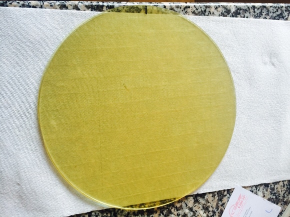 Yellow tape with smooth texture and bright color lying on white background.