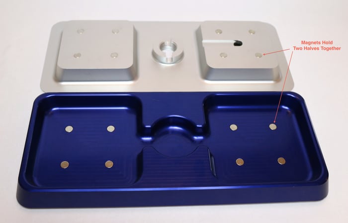 Blue metal tray with two silver magnets labeled "two halves" in separate compartments.