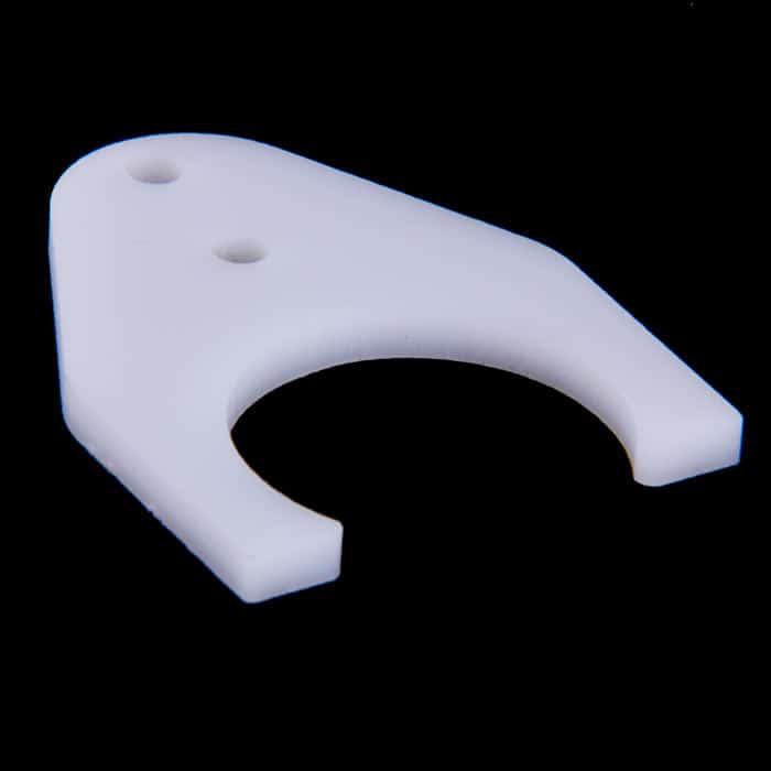 White plastic component with three holes and fork-like shape, likely used in CNC machine accessories.