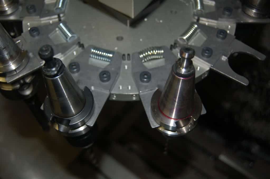 A metal spring fork with conical shape and small hole at its base.