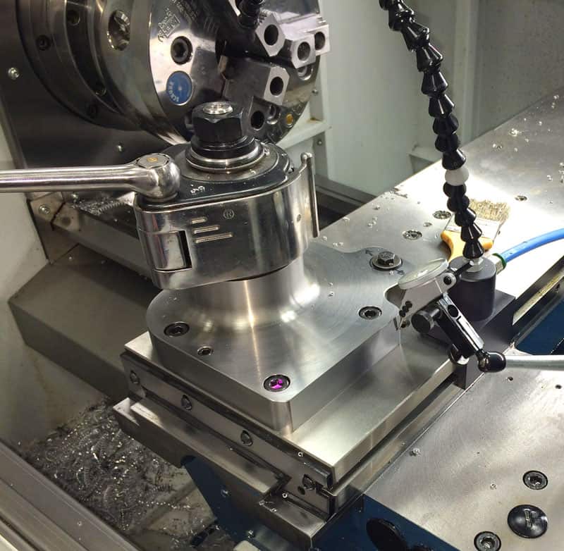 Precision turning center with quill-type turret head.