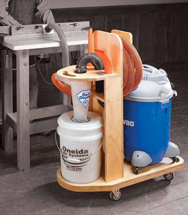 Wooden tool cart with vacuum cleaner and bucket on dark gray floor.