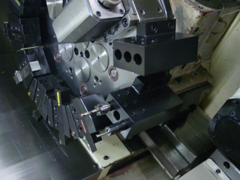 Close-up of a double tool attachment on a CNC milling machine.