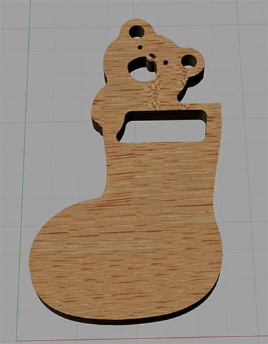 Wooden bear-shaped object with handle on a gray background.