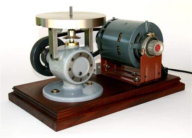 Antique die filer tool with rotating head and wooden base.