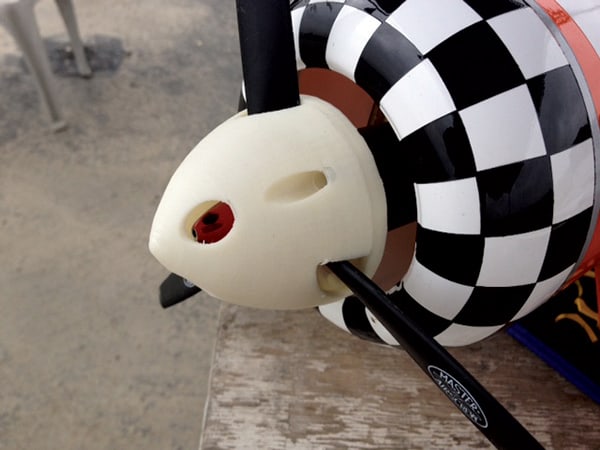 3D printed spinner with checkered pattern and red circle.