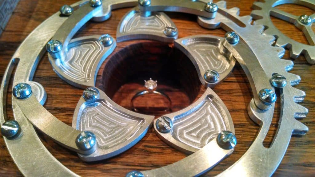 Intricate metal component with interlocking gears and central circular opening.