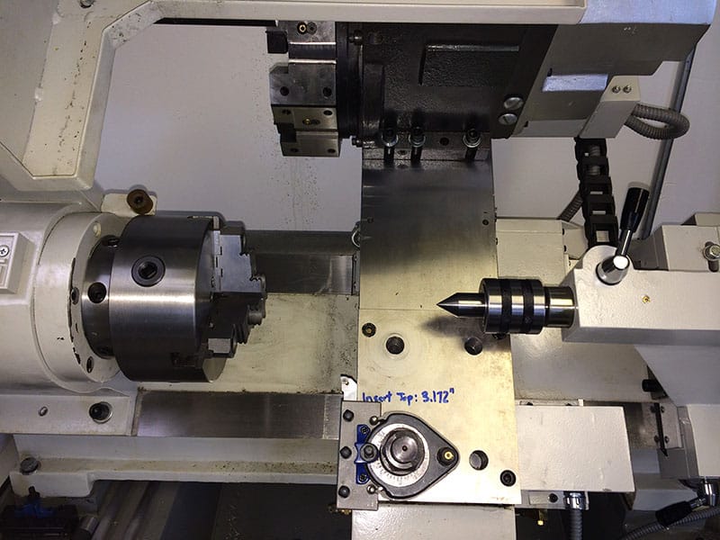 Machine tool tailstock with mechanical components.