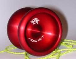 Red yo-yo with white Addict logo and bright yellow string.