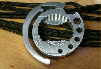 Metal object with a circular shape and central hole, featuring notched edges.