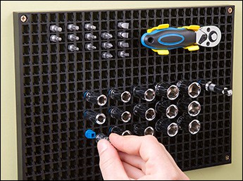 Hand adjusting amplifier knobs in a professional audio equipment setting.
