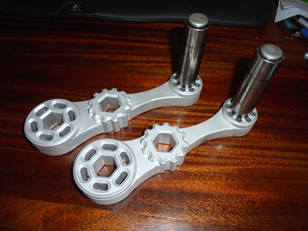 Two metal handles with threaded ends.