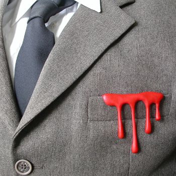 Gray suit jacket with red liquid stain on breast pocket.