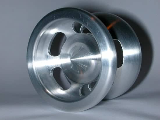 Silver metal object with four holes.