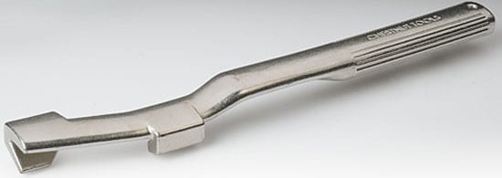 A silver metal wrench extender or cheater bar with a flat end, long handle, and "WRENCH" text.