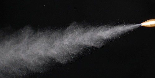 White mist sprayed from nozzle.