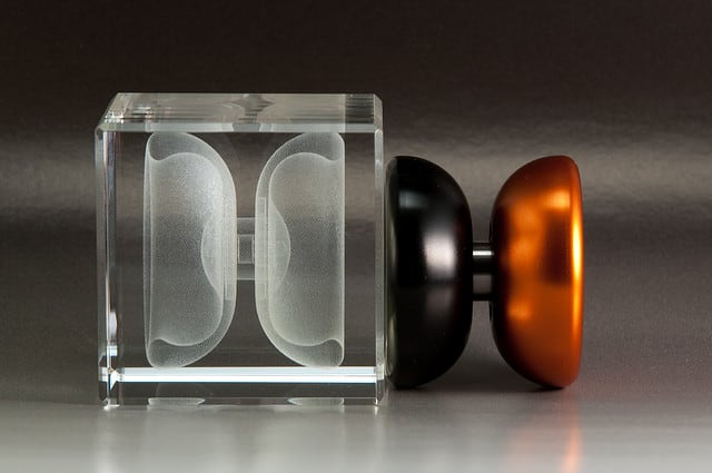 Glass cube with frosted design and orange yoyo.