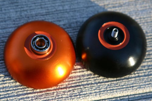 Gold and black yoyos with small metal rings.