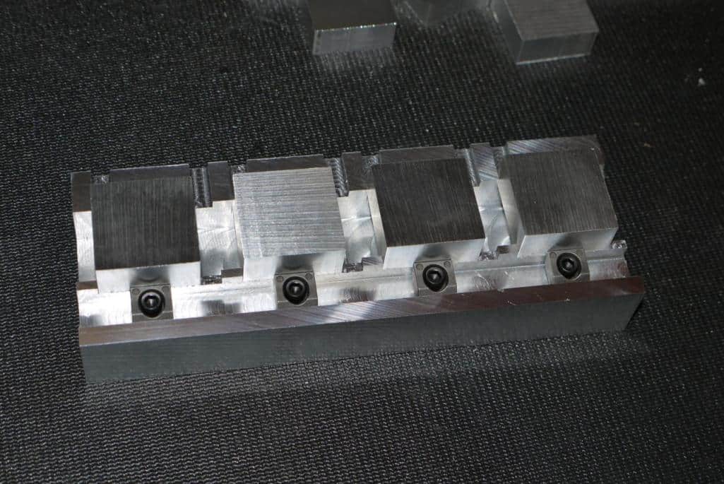 Rectangular metal block with small black holes.