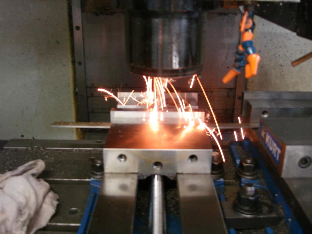 Metal cutting sparks emitted from machinery.