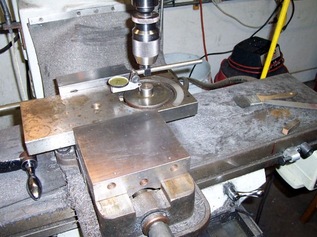 A precision metal drilling and milling machine with a turret head.