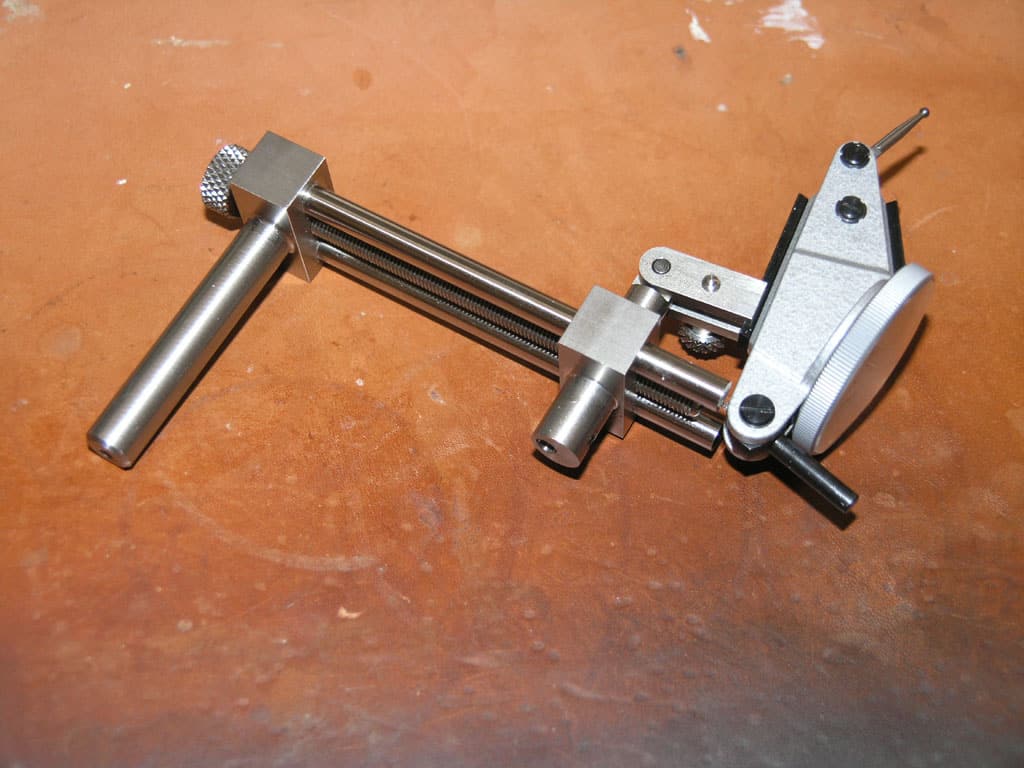 Metal device with T-shaped handle and round component, likely used for precision measurement or adjustment.