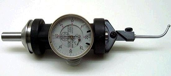 Precision measuring device with white face and black numbers on light gray background.