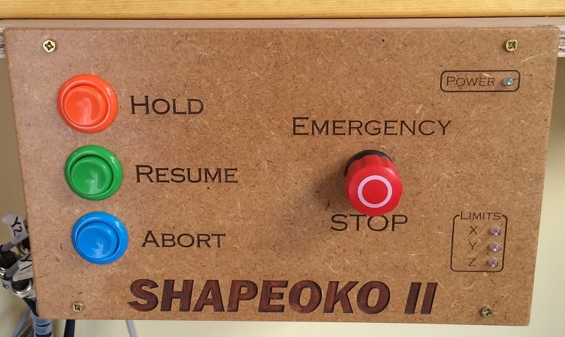 Control panel with HOLD, RESUME, ABORT and emergency stop buttons, along with engraved power and limit labels.