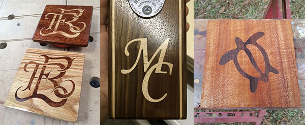 Wooden objects with intricate letter, symbol, and turtle inlays showcasing woodworking techniques.